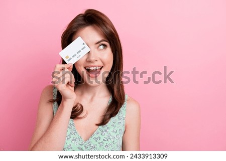 Photo of excited glad lovely girl wear trendy print clothes close face look up empty space banner isolated on pink color background