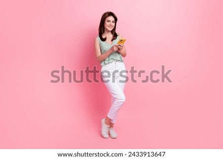 Full length photo of adorable stunning girl use modern device apple iphone read news post isolated on pink color background