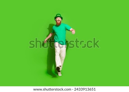 Full body photo of funky positive person walking empty space advert isolated on green color background