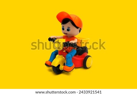 Mini Tricycle Cartoon Scooter Toy With Yellow Background.