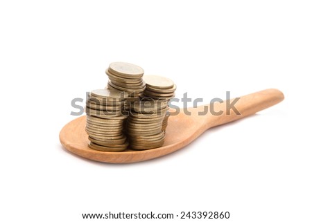 Coins  on wooden spoon isolated with white background.