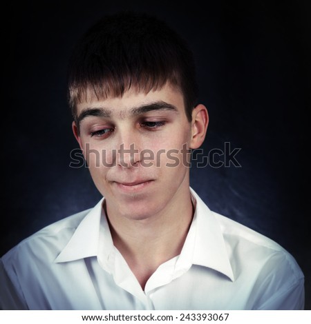 Toned Photo of Pensive Young Man on the Black Background