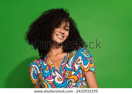 Portrait of sweet curly hair chevelure model woman wearing colorful trendy blouse toothy smiling isolated over green color background