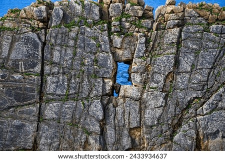 rock wall with a window to the sea
