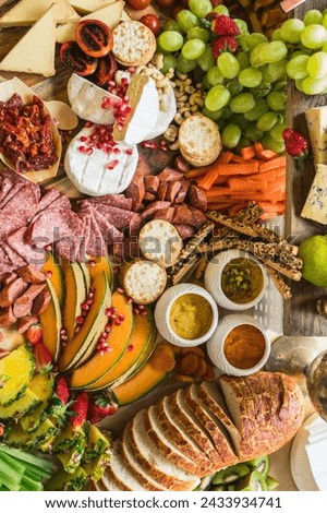 Cheese Lover's Delight: Overhead View of Cheese Platter with Assortment of Cheeses, Fruits, Breads, and Snacks in 4K Ultra HD Resolution