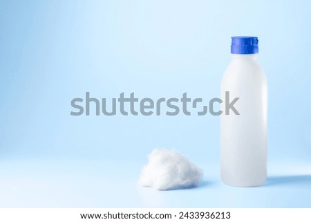 medical syringe and a bottle of injectable medication in a pharmaceutical laboratory blue background copy space