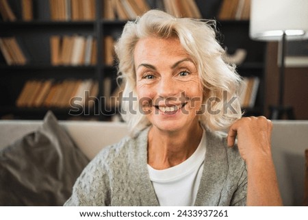 Portrait of confident stylish European middle aged senior woman. Older mature 60s lady smiling at home. Happy attractive senior female looking camera close up face headshot portrait. Happy people Royalty-Free Stock Photo #2433937261