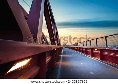 Cycle path over the architectural Hanzeboog railway bridge that crosses the river 'De IJssel' near the capital Zwolle Royalty-Free Stock Photo #2433937953