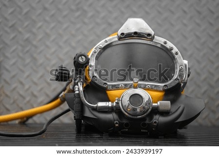 Commercial diving helmet closeup photo with steel background