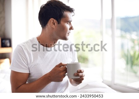 Man, coffee and bed with window for morning, wakeup, daydream or thinking with sunlight and caffeine. Young and male person with looking and relax for ponder, thought idea indoor for weekend Royalty-Free Stock Photo #2433950453