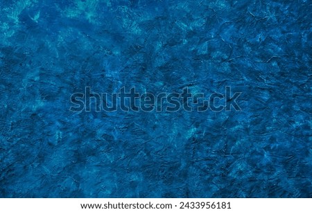 Artistic grunge navy blue stucco wall texture background. Abstract creative dark textured backdrop. Beautiful rough wallpaper with copy space for design.