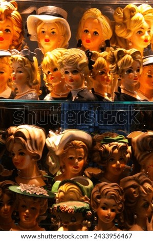 Doll Heads in a China Cabinet Royalty-Free Stock Photo #2433956467