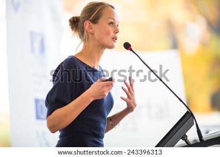 Pretty, young business woman giving a presentation in a conference/meeting setting (shallow DOF; color toned image) Royalty-Free Stock Photo #243396313