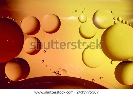 Macro photography. Orange-yellow drops of oil or serum texture background. Oil drops on the water's surface.  Royalty-Free Stock Photo #2433975387