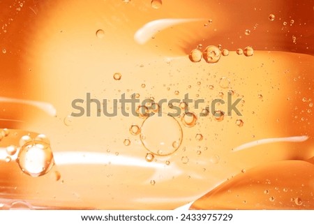 Macro photography. Yellow drops of oil or serum, and beer bubbles texture the background. Oil drops on the water's surface. Royalty-Free Stock Photo #2433975729