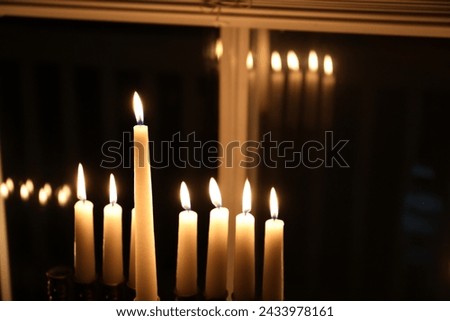 Hanukkah candles in a window.