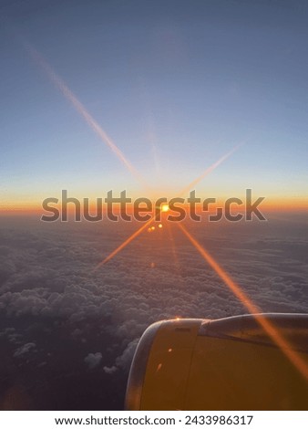 A picture of the sunset on an airplane.