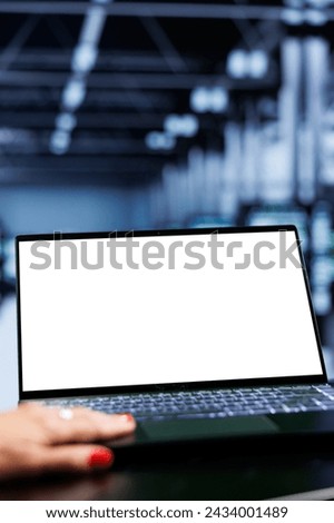 Close up shot of mock up laptop used by admin in server room delivering massive computing power, capable of processing and storing vast amounts of data and controlling network resources