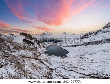 Lake Bachalpsee with Jungfrau, Eiger, and Monch Peaks with an early snow. Royalty-Free Stock Photo #2434007771
