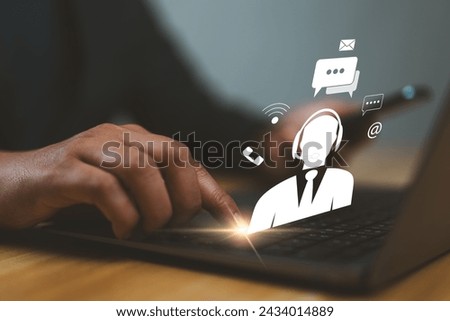 A guy indicates an operator's emblem, which includes iconography for after-sales services. Customer satisfaction communication channel Royalty-Free Stock Photo #2434014889