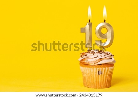Birthday Cake With Candle Number 19 - Photo On Yellow Background.