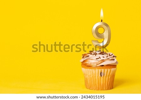 Birthday Cake With Candle Number 9 - Photo On Yellow Background.