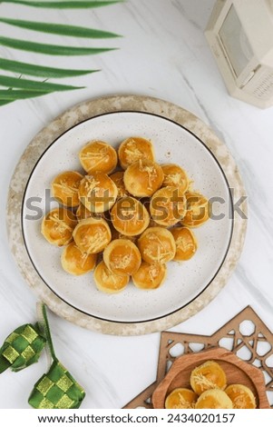 Top view of Kue Nastar or Pineapple tart cookies, Indonesian popular cookies during lebaran or hari raya, Eid al fitr and Eid al Adha. Ramadan Islamic theme for text and background. Royalty-Free Stock Photo #2434020157