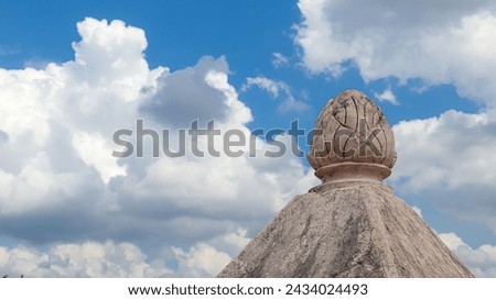 bright blue cloudy sky above the domed roof of a traditional building