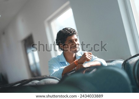 Asian men looking randomly for photoshoot at some function. Blue color and Sunrise time. Royalty-Free Stock Photo #2434033889