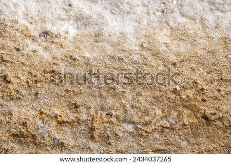 background of an icy road sprinkled with sand in winter