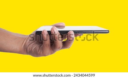 Hands are holding a yellow background mobile phone, for advertising online selling products