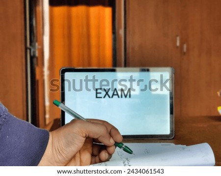 Picture of a person studying preparing for exam with EXAM written on a placard in background