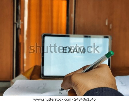Picture of a person studying preparing for exam with EXAM written on a placard in background