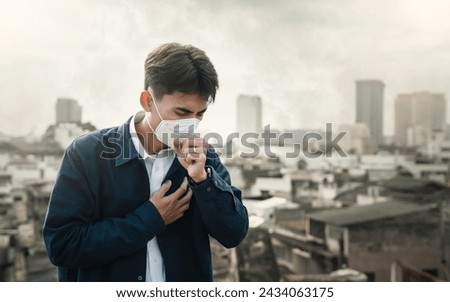 air pollution quality of dust PM 2.5 is toxic and dangerous to health. Business man wearing Protection mask unhealthy air pollution dust smoke in an urban city and smog with bad weather Royalty-Free Stock Photo #2434063175