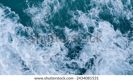Stunning aerial top view background image of sea water. White waves splashing in the deep sea Behind the scenes of photographing sea waves on Koh Samui with a drone.