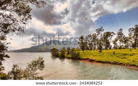 Scenic view of beautiful Mulshi dam backwaters on a cloudy sunny day surrounded by lush green mountains. It is a famous tourist spot near Pune in Maharashtra state. Royalty-Free Stock Photo #2434084253