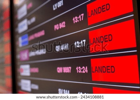 Digital timetable board at the airport with flights status being displayed. Royalty-Free Stock Photo #2434108881