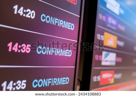 Digital timetable board at the airport with flights status being displayed. Royalty-Free Stock Photo #2434108883