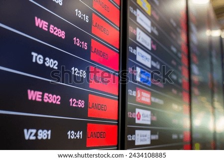 Digital timetable board at the airport with flights status being displayed. Royalty-Free Stock Photo #2434108885