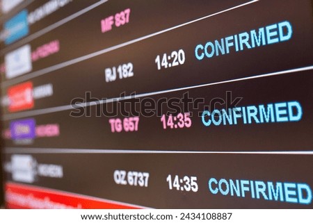 Digital timetable board at the airport with flights status being displayed. Royalty-Free Stock Photo #2434108887