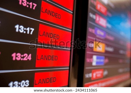 Digital timetable board at the airport with flights status being displayed. Royalty-Free Stock Photo #2434111065