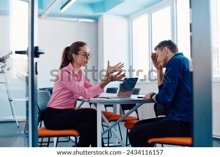 A furious business director of a startup office berating her employee for business mistakes and errors Royalty-Free Stock Photo #2434116157