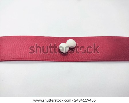 lizard eggs on a red ribbon