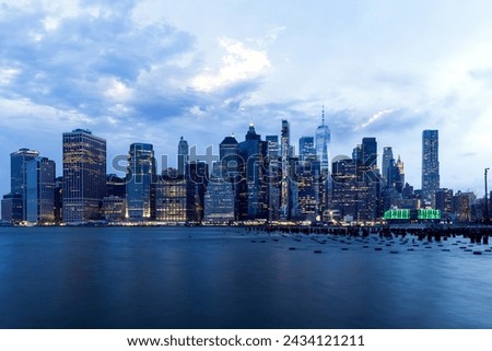 Manhattan skyline in New York across the river, showcasing the impressive architecture and modern cityscape at sunset