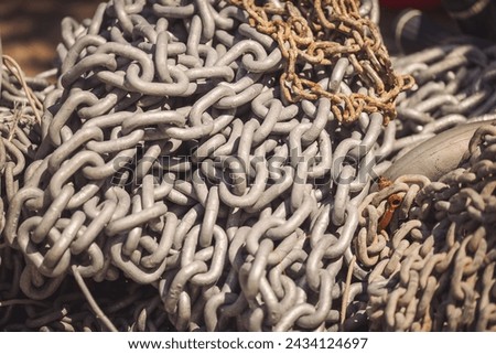 Iron chains piled in a pile. pile of heavy metal chain, marine anchor chains. background chain rusty link streel. 