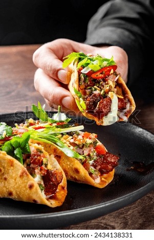 man hand holding taco traditional mexican food