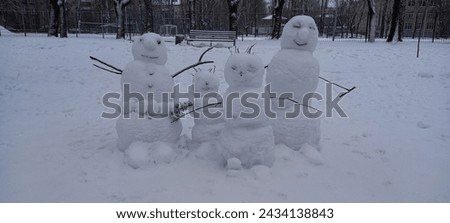 Snow women against a background of snow in daylight for a festive atmosphere.