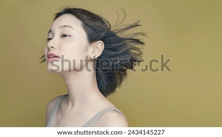 Hair care concept of young Asian woman. Beauty salon. Cosmetics. Royalty-Free Stock Photo #2434145227