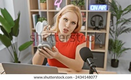 Blonde woman in red presenting a podcast at a radio studio desk with headphones.
