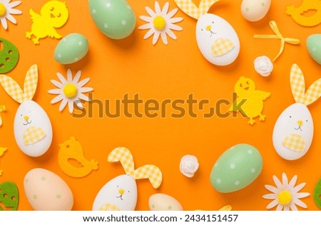 Easter eggs and decoration on color background, top view